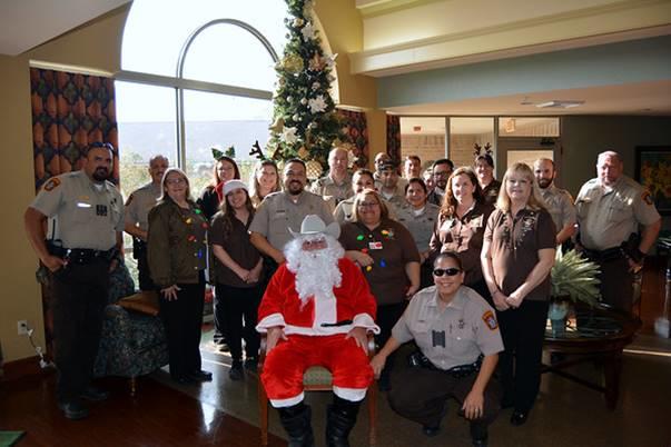 Santa Sheriff and staff in front of christmas tree